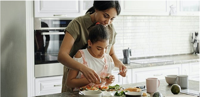 A mother and daughter bonding over food preparation